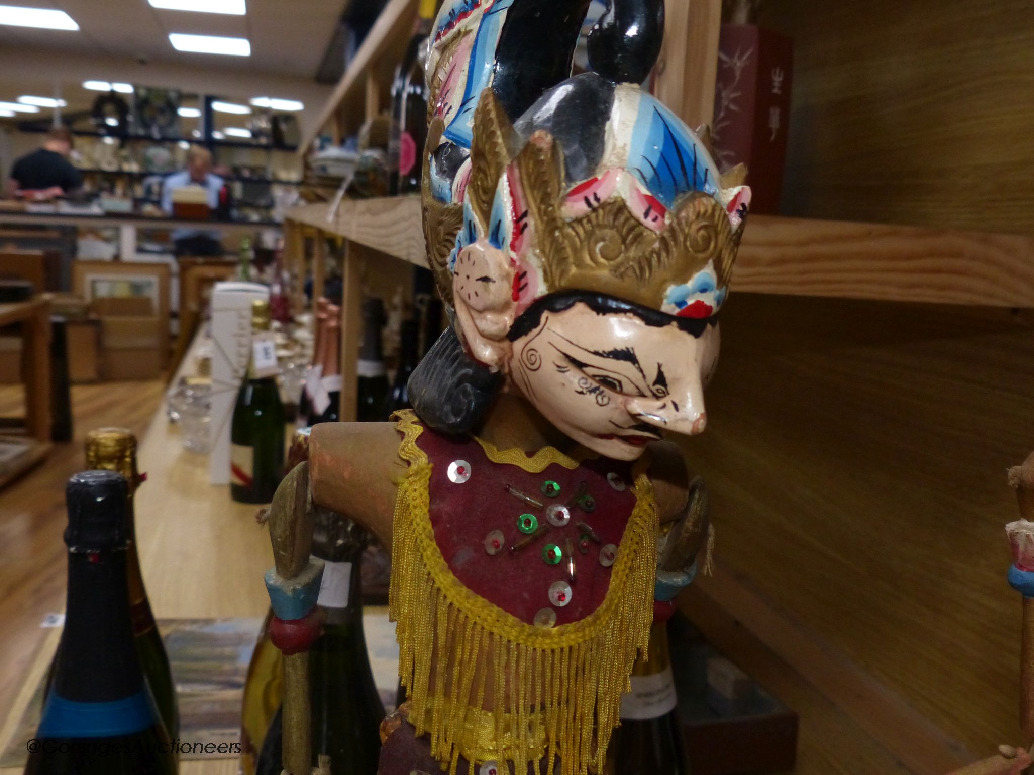 Two Indonesian stick puppets and a book relating to stick puppets, tallest 70cm